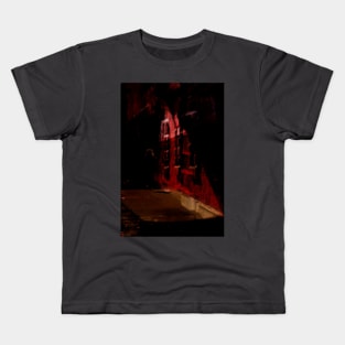 Special processing. Person walking at night, on dark street, with stone walls. Red. Kids T-Shirt